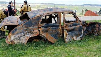 Rusty Car Wreck in a Historical Reenactment Scene. Minsk, Belarus - May 9, 2022 photo