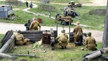 Historical Military Reenactment Scene with Soldiers in a Trench. Minsk, Belarus - May 9, 2022 photo