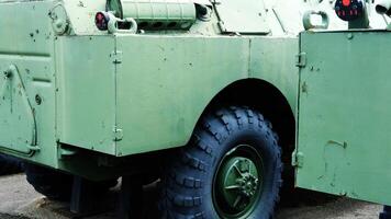 Side View of Military Armored Vehicle with Rugged Tire photo