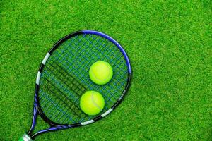 Tennis Racket and Balls on Grass photo