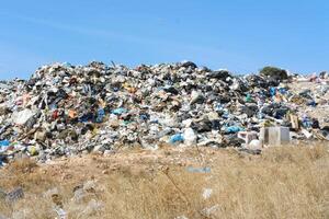 Large Heap of Garbage at City Dump with Clear Sky photo