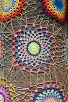 Hand-Knitted Tree Trunk Decoration with Colorful Patterns photo