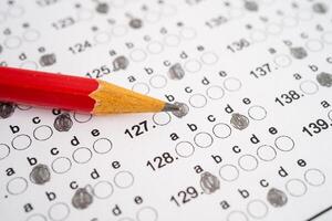 Answer sheets with pencil drawing fill to select choice, education concept. photo