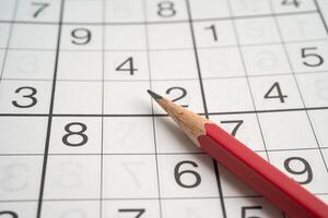 Sudoku puzzle game playing to challenge brain. photo