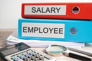 Salary., Employee. Binder data finance report business with graph analysis in office. photo