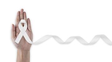 Hand with white ribbon. represents a mental health prevention program , mental health awareness campaign. photo