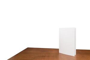 Stand mockup frame menu card tent blur key background design picture pattern. White paper sheet tent card on wooden table white isolated background photo