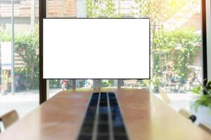 Conference room with blank, empty TV screen. Monitor mock up. Business meeting room with LCD screen for presentation, advertising. Modern, contemporary office. Free, copy space. photo
