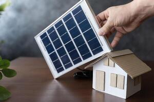 Close up view of alternative energy engineer pointing at solar panels for future energy in studio. photo