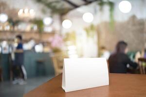 Blank menu frame label mockup. Menu frame mockup n wooden table in bar restaurant, stand for booklet with white sheet of acrylic paper tent card photo