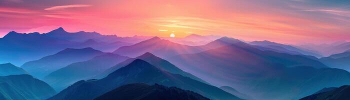 A mountain range with a pink and purple sky in the background photo
