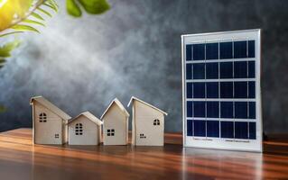 Close up view of alternative energy engineer pointing at solar panels for future energy in studio. A small cardboard house and a solar panel close up. photo
