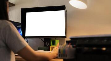 Cropped image of a businesswoman is using a white blank screen desktop computer at the white working desk. photo