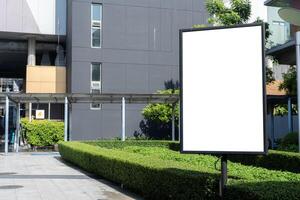 Mock up outdoor signboard on black stand with clipping path on walkway, empty space for insert advertising or graphic design. photo