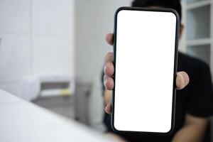 Smart phone with white screen background in toilet, restroom or WC. Closeup of hands using mobile phone with blank copy space screen, empty white screen for advertising text in toilet photo