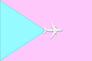 Flat lay design of travel in summer concept. Top view of an airplane on blank pink and blue pastel color screen with copy space. travel on summer trip photo