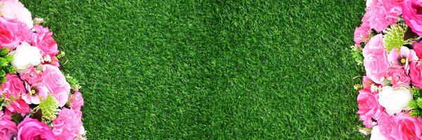Beautiful wall from various artificial creeper plant for background, staircase green artificial grass with pink flower. Combination of plants photo