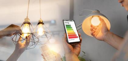 Man change a new electric bulb, hand using remote control open air conditioning 26 degrees make a home more energy efficient. Home appliance energy efficient. photo