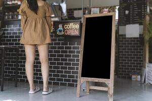 Blank advertising panel. Mock up menu frame standing in Bar restaurant cafe. space for text. empty black board. photo