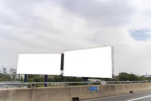 Blank billboard ready for new advertisement. Mockup image of billboard beside highway. Large blank billboard photo