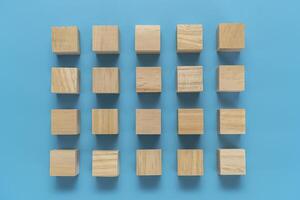 Simple cubic shape assembled from blocks on a blue background. Top view photo