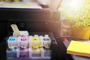 The printer is fully functional,Located on the desk. Ink tank that looks smeared in ink photo