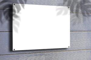 An old pine wooden billboard with a blank poster on the wall. Wooden texture for background or mockup. photo