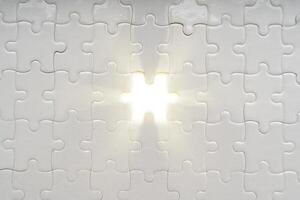 Solution concept. soft sun light ray coming through under a missing piece of jigsaw puzzle photo