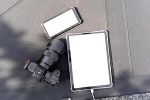 Top view of black table with smartphone, tablet, camera and copy space, include clipping path photo