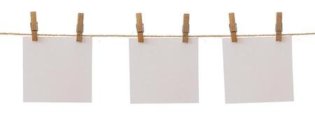 Three frames that hang on a rope with clothespins and isolated on white. Blank cards on rope mockup template, clipping path. photo