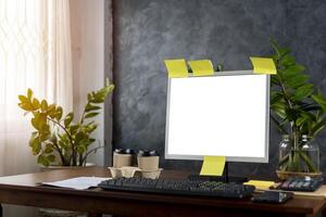 a computer with blank screen, lamp, plant, organizer and glasses, cup, mouse, three datebooks and pencils, Front view. Concept of work. photo