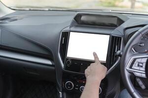 Monitor in car with isolated blank screen use for navigation maps and GPS. Isolated on white with clipping path. Car detailing. Finger touching blank screen. photo