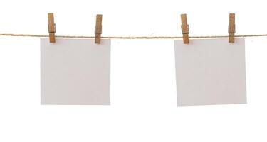 Two frames that hang on a rope with clothespins and isolated on white. Blank cards on rope mockup template, clipping path. photo