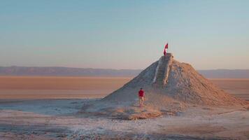 Large view of man climbing the sightseeing point of dried salted lake in sahara. video