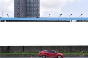 A mockup of a full horizontal billboard. Large billboards in the city during daytime with large buildings in the background. photo
