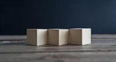 Blank wooden cube blocks on the table. Three pieces are placed side by side, six sides photo