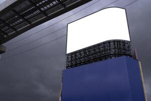 Brightly lit blank billboard stands out from the downtown area around at the early evening hours. photo