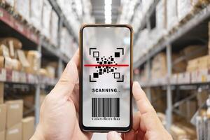 Online shopping concepts with youngman using smartphone with qr code on product package box. e commerce market. photo