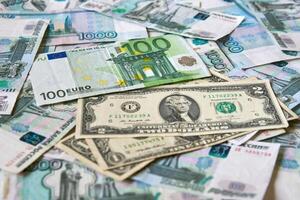 background of paper bills dollars, euros and rubles. Currency exchange rate photo