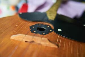 Close-up image of a domra with three golden strings. Selective focus. photo