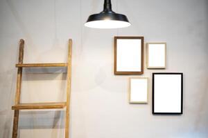 Cropped shot of stylish workspace with mock up frame, stationery in living room. photo