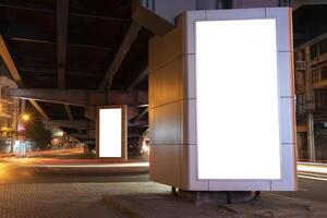 An empty white vertical light box installed under the expressway photo