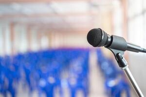 Microphone soft focus on blur abstract background lecture hall, seminar meeting room in business event, educational academic classroom training course. photo