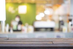 Wood table background, Shelf at cafe shop over blur cafe with bokeh light background photo