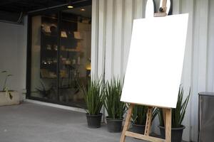 The white blank sheet is placed on located in front of a coffee shop photo