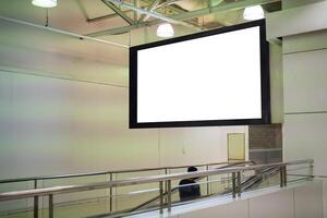 Blank large horizontal poster in public places. A mockup billboard near escalator in a shopping mall photo