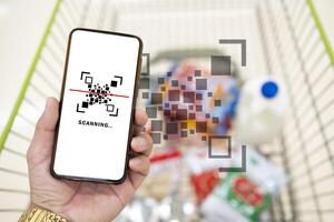 Man use smartphone scanning QR code for pay photo