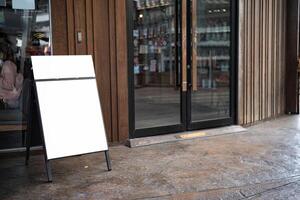 The white blank sheet is placed on located in front of a coffee shop. photo