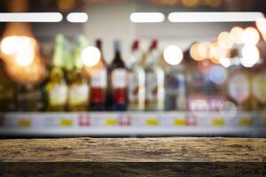 Bartender or male cavist standing near the shelves of wine bottles holds a glass of wine photo