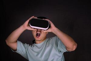 man using virtual reality headset alone in studio gray background. photo